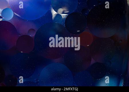 Photo of oil on a water surface with bubbles. Abstract colorful background. Macro close-up, not illustration . Stock Photo