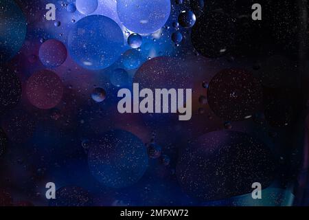 Photo of oil on a water surface with bubbles. Abstract colorful background. Macro close-up, not illustration . Stock Photo