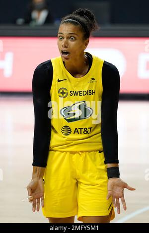 Las Vegas Aces forward Alysha Clark, left, greets Seattle Storm center