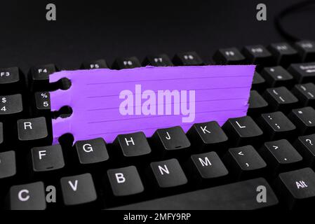Colored sticker lying on keyboard. Important message written over paper. Stock Photo
