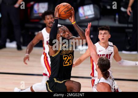 Los Angeles Lakers forward LeBron James (23) goes up for a shot in front of Miami Heat's Kelly Olynyk, right front, as Jimmy Butler, left rear, and Tyler Herro, right rear, look on during the second half of Game 2 of basketball's NBA Finals, Friday, Oct. 2, 2020, in Lake Buena Vista, Fla. (AP Photo/Mark J. Terrill)
