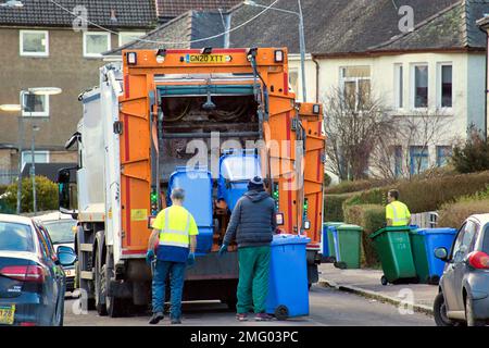 Bin lorry dustmen collecting on suburban street Stock Photo