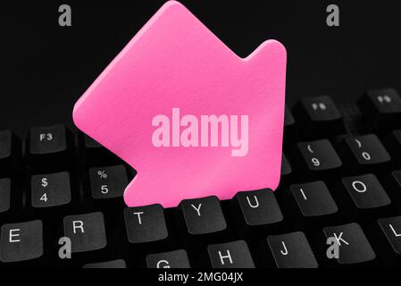 Colored sticker lying on keyboard. Important message written over paper. Stock Photo