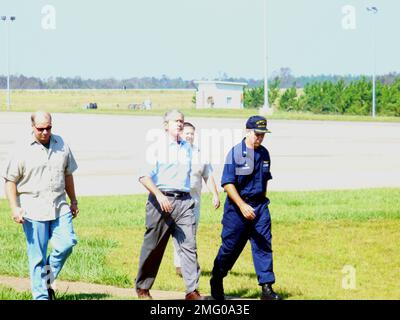 . President Bush and CAPT David Callahan (CO ATC Mobile) near flight line. Hurricane Katrina Stock Photo