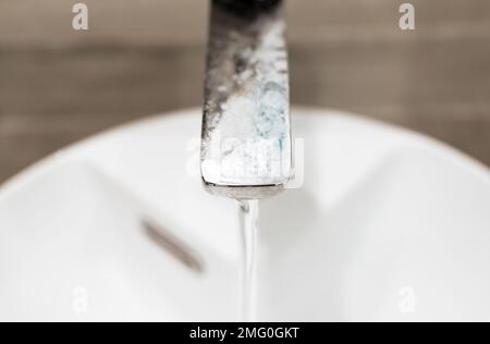 Dirty tap, faucet with limescale on chrome surface. Lime scale on stainless steel, metal. High quality photo Stock Photo