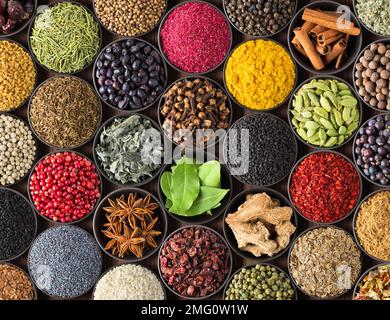 Fresh spices and herbs for food. Colorful condiments as background, top view. lot seasonings in cups, on table Stock Photo