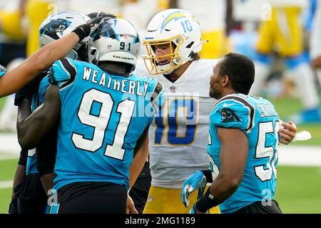 Los Angeles Chargers quarterback Justin Herbert (10) congratulates Carolina  Panthers defensive end Stephen Weatherly (91) and defensive end Brian Burns  (53) after an NFL football game against the Los Angeles Chargers Sunday,