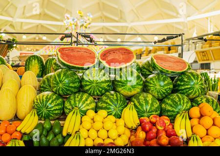 Assortment of fresh organic fruits and vegetables on market shelves close up. Healthy food, balanced diet concept. Natural farmers background Stock Photo