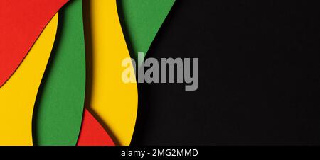 Black History Month color background. Abstract paper cut style composition with layers of geometric shapes and wavy lines in red, yellow, green colors Stock Photo