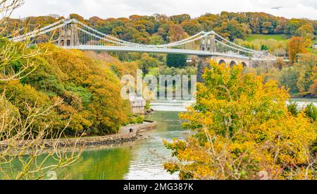 The Menai Suspension Bridge, over the Menai Straits that separate Anglesey from the mainland of Wales. Taken in November 2021. Stock Photo