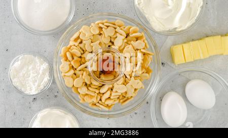 Cracker crust for cheesecake recipe. Homemade mini cheesecakes preparation process, close-up ingredients Stock Photo