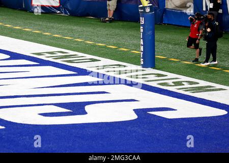 The words 'End Racism' are seen painted in an end zone during an NFL  football game