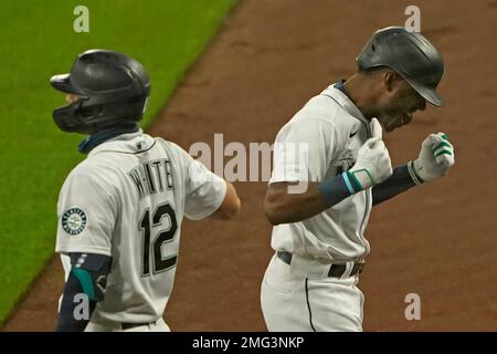 Seattle Mariners' Kyle Lewis, left, is greeted by Taylor Trammell