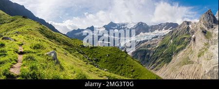 The massif of Grosses Fiescher horn peak and Berghaus Baregg chalet - Switzerland - Grindelwald. Stock Photo