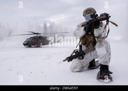 January 10, 2023 - Joint Base Elmendorf-Richardson, Alaska, USA - A U.S. Air Force Special Tactics Airman with the 24th Special Operations Wing, Detachment 1, also known as Deployment Cell or D-Cellâ provides security while an Alaska Army National Guard HH-60M Black Hawk lands at Camp Mad Bull, Joint Base Elmendorf-Richardson, Alaska, January. 10, 2023. AKARNG aviators from the 2-211th General Support Aviation Battalion provided CASEVAC support for the training. Based out of MacDill Air Force Base, Fla., D-Cell consists of 54 members across 15 job codes forming four agile teams, whose primary