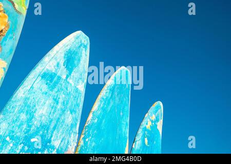 Beautiful painted surfboards on a blue sky background. The concept of active recreation and tourism. Stock Photo