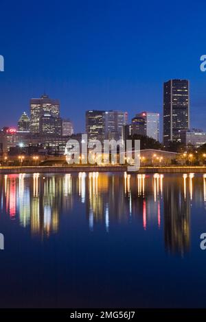 Montreal skyline reflected in Peel basin at dawn in spring, Quebec, Canada. Stock Photo