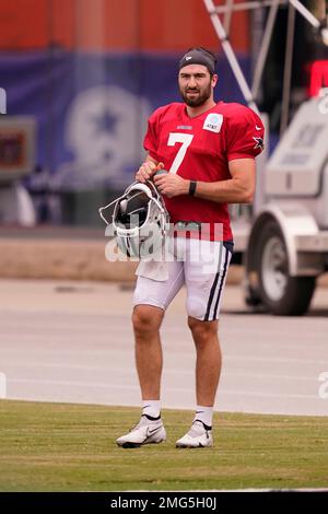 Dallas Cowboys quarterback Ben DiNucci, front left, takes a snap