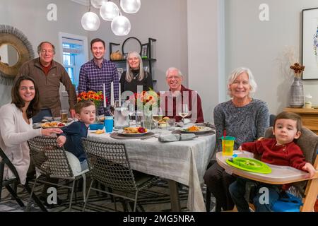 Three generation family portrait at dining room table; Thanksgiving Day holiday; Philadelphia; Pennsylvania; USA Stock Photo