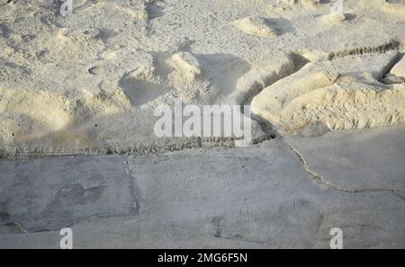 Part of a sunny beach in Malta with an unusual rocky relief. Background. Stock Photo