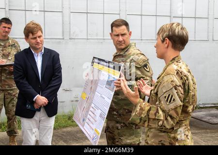 Robby Wehagen, House of Representatives deputy chief of staff and legislative director, talks to CW4 Natasha Ryan, an aviation safety officer assigned to 603rd Aviation Support Battalion, and Lt. Col. Robert Cuthbertson, Hunter Army Airfield garrison commander, during a hangar tour at Hunter Army Airfield, August 22, 2022. Wehagen toured the airfield to learn about upcoming projects and to discuss the conditions of aircraft hangars. Stock Photo