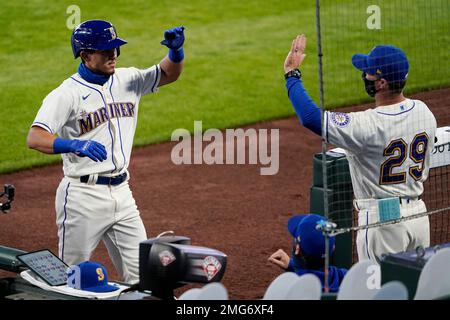 Seattle Mariners' Sam Haggerty is greeted in the dugout after