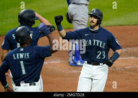 Seattle Mariners' Kyle Lewis (1) is greeted at the dugout by Taylor  Trammell, right, after Lewis hit a solo home run against the Houston Astros  during the second inning of a baseball