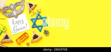 Card with text HAPPY PURIM, Hamantaschen, carnival mask and rattles on yellow background with space for text Stock Photo
