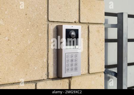 Modern intercom on brick wall Stock Photo