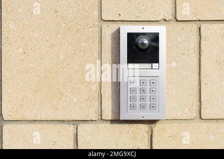 Modern intercom on brick wall Stock Photo