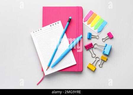 Set of stationery with notebooks on light background Stock Photo