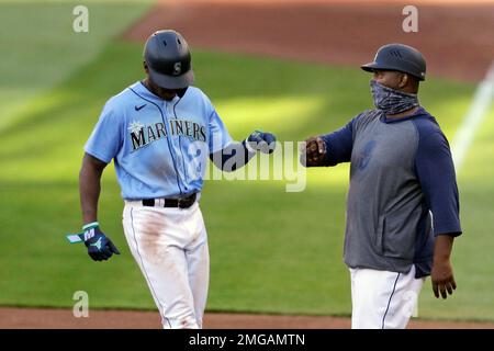 Seattle Mariners' Kyle Lewis, left, is greeted by Taylor Trammell