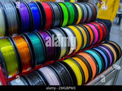 Many multi-colored spools of thread of filament for printing 3d printer. Material coils for printing 3D printer. Spools of 3D printing motley different colors filament. ABS wire plastic for 3d printer Stock Photo