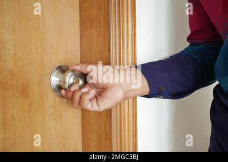 Man's Hand Opening door close up  Stock Photo