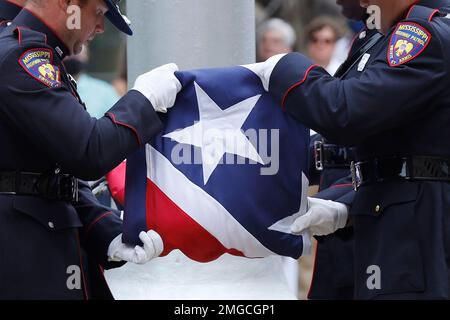 A Mississippi Highway Safety Patrol honor guard carefully folds