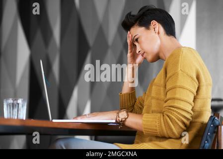 Feeling the pressure. an attractive young businesswoman looking stressed out while working in her office. Stock Photo