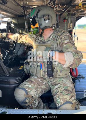 Air Force  special mission aviator Master Sgt. Bryan Judy, a member of the New York Air National Guard’s 106th Rescue Wing makes some adjustments while getting ready to launch on an HH-60 Pave Hawk in Campo Grande, Brazil on August 23, 2022 , while participating in Exercise Tapio. The New York Air National Guard sent 100 personnel to participate in the exercise as part of the New York National Guard State Partnership Program relationship with Brazil.( Stock Photo