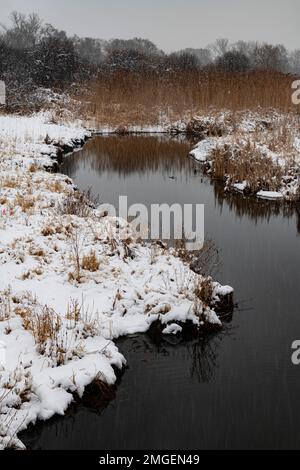 Snow streaks show up over Rock Run as it flows through Rock Run Forest Preserve in Will County, Illinois Stock Photo