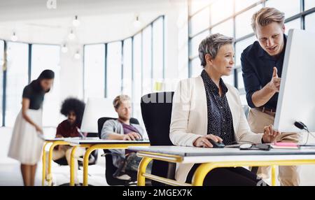 Hes adding a fresh twist in the winning formula. a group of creative designers hard at work in their modern office. Stock Photo