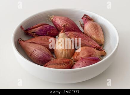 Shallots or Red Onion in a white bowl Stock Photo