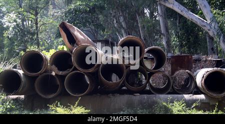 Discarded storm drain pipes lying in a junkyard : (pix Sanjiv Shukla) Stock Photo