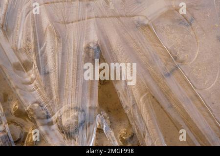 Ice pattern on a sandy beach Stock Photo