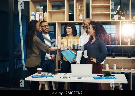 Youre just the person we need for this project. a group of designers having a discussion in a modern office. Stock Photo