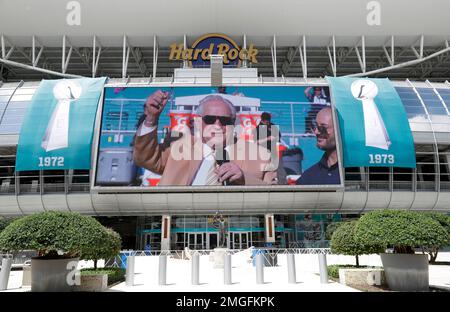 Mary Anne Shula hugs Tom Garfinkle, President and CEO of the Miami  Dolphins, during a ceremony honoring former head coach Don Shula during  half time of an NFL football game against the