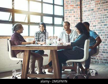 Coming together is a beginning. Working together is success. a team of entrepreneurs collaborating in a modern office. Stock Photo