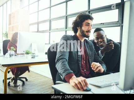 The best design duo. two businessmen working on a computer in their office. Stock Photo