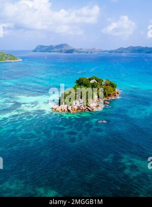 Drone view from above at a tropical beach in Seychelles. Anse Volbert beach Praslin with granite boulders rocks Stock Photo