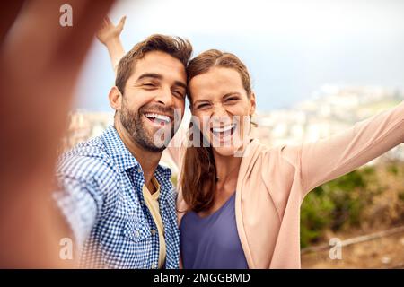 Making wild memories. an affectionate couple taking selfies outside. Stock Photo