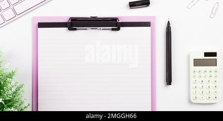 Pot with Plant and Coffee Cup Standing on White Desk. Important infrormation written on paper. Different Office Supplies, Pencils, Pens, Marckers Stock Photo