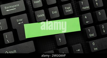 Sticker lying on black keyboard. Important message written over paper. Stock Photo
